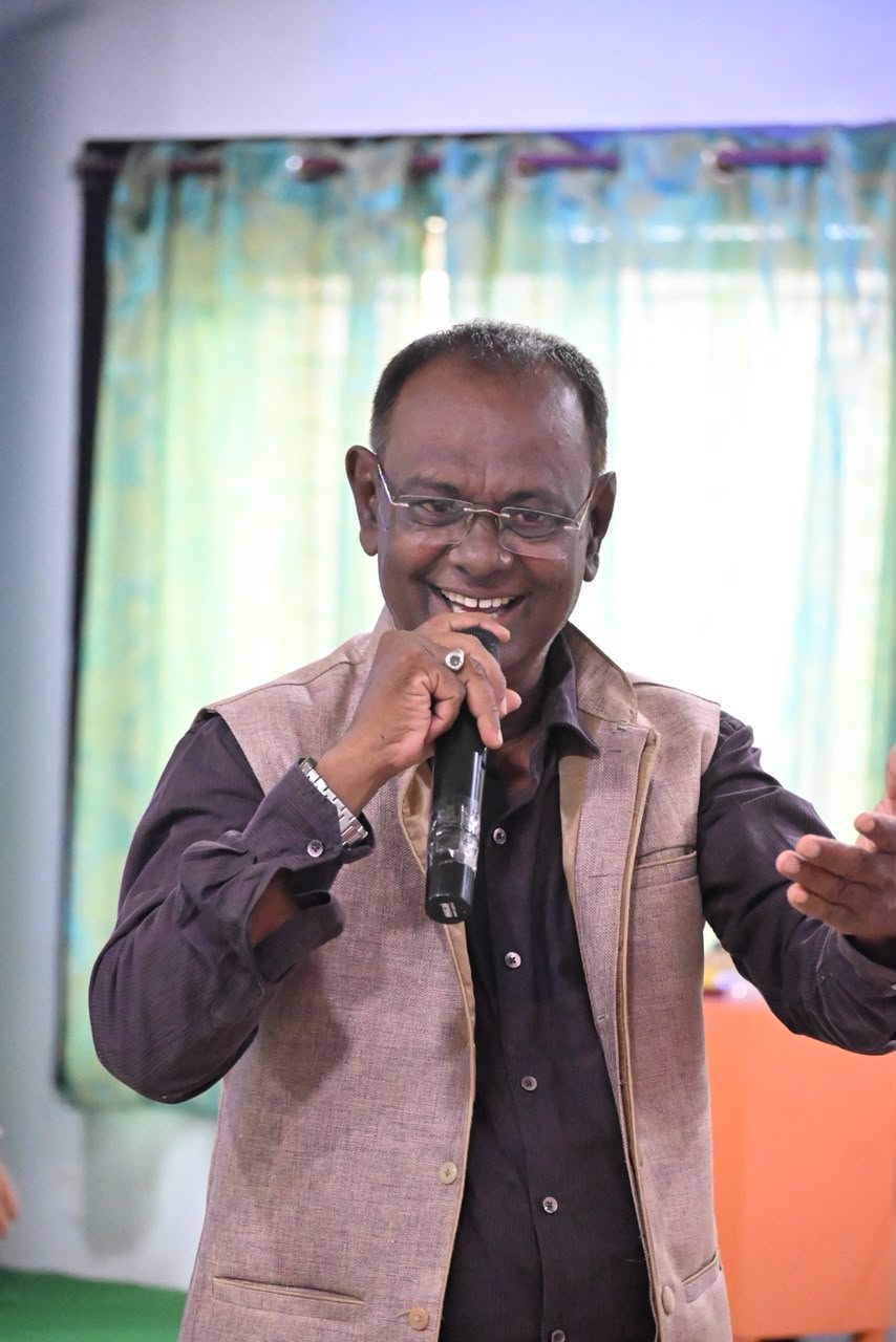 Dr. Abdul Hakim Khan speaking with a microphone
